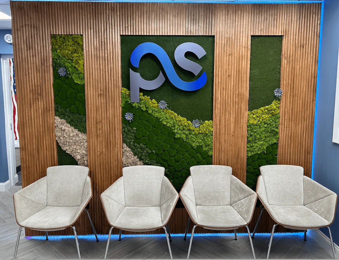 The shared PS Medical Group reception area, with the practice mark on the wall